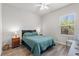 Inviting bedroom with a full-sized bed, nightstands, and a window at 808 Overlook Grove Dr, Winter Haven, FL 33884