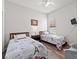 Cozy bedroom with twin beds, a ceiling fan, and hardwood flooring at 808 Overlook Grove Dr, Winter Haven, FL 33884
