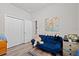 Cozy bedroom featuring a futon, closet, and hardwood flooring at 808 Overlook Grove Dr, Winter Haven, FL 33884