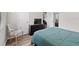Well-lit bedroom with wood floors, a blue bedspread, and a relaxing atmosphere at 808 Overlook Grove Dr, Winter Haven, FL 33884