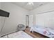 Comfortable bedroom featuring two twin beds, closet, and a ceiling fan at 808 Overlook Grove Dr, Winter Haven, FL 33884