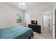 Well-lit bedroom featuring a full-sized bed, a closet, and a TV at 808 Overlook Grove Dr, Winter Haven, FL 33884