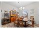 Formal dining room with wooden table and chairs, built-in hutch, wood-look floors, and a decorative chandelier at 808 Overlook Grove Dr, Winter Haven, FL 33884
