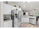 Modern kitchen featuring stainless steel appliances, white cabinets, granite countertops and wood-look flooring at 808 Overlook Grove Dr, Winter Haven, FL 33884