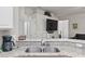 Bright kitchen with granite countertops, stainless steel sink and faucet, and modern appliances at 808 Overlook Grove Dr, Winter Haven, FL 33884