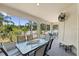Enclosed patio with a fan features multiple seating areas with views of the landscaped backyard and natural surroundings at 808 Overlook Grove Dr, Winter Haven, FL 33884