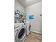 Laundry room featuring a washer, dryer, and shelving for cleaning supplies at 808 Overlook Grove Dr, Winter Haven, FL 33884