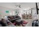 Spacious living room features an open floor plan with bar seating to the kitchen with stainless steel appliances at 808 Overlook Grove Dr, Winter Haven, FL 33884