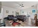 Comfortable living room with leather sofas, area rug, ceiling fan, and access to the outdoor patio at 808 Overlook Grove Dr, Winter Haven, FL 33884