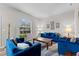 Cozy living room featuring modern decor, large window, and plush blue seating arrangement on stylish rug at 808 Overlook Grove Dr, Winter Haven, FL 33884