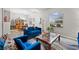 Comfortable living area with blue upholstered seating, a large picture window, and adjacent dining space at 808 Overlook Grove Dr, Winter Haven, FL 33884