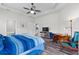 The main bedroom has wood-look floors, ceiling fan, desk area and connecting bathroom at 808 Overlook Grove Dr, Winter Haven, FL 33884