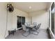 Covered back patio featuring outdoor seating, overhead fan, and pleasant views at 808 Overlook Grove Dr, Winter Haven, FL 33884