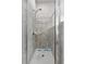 Tiled shower with a glass door, offering a clean and modern design at 808 Overlook Grove Dr, Winter Haven, FL 33884