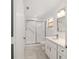 Bright bathroom with marble tile flooring, a glass shower, and a modern vanity at 8712 Sw 92Nd St # C, Ocala, FL 34481