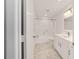 Recently renovated bathroom featuring marble flooring, glass shower, and white vanity at 8712 Sw 92Nd St # C, Ocala, FL 34481
