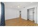 Open bedroom with hard wood floors and attached open closet at 8712 Sw 92Nd St # C, Ocala, FL 34481