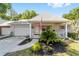 Charming single-story home with a brick facade, attached garage, and a cozy front porch adorned with an American flag at 8712 Sw 92Nd St # C, Ocala, FL 34481