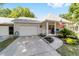 Charming single-story home with a brick facade, attached garage, and a cozy front porch adorned with an American flag at 8712 Sw 92Nd St # C, Ocala, FL 34481