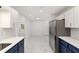 Bright kitchen features updated cabinets, stainless steel appliances, and stunning marble floors at 8712 Sw 92Nd St # C, Ocala, FL 34481