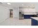 The kitchen is designed with stainless steel appliances, white cabinets, and marble tile floors at 8712 Sw 92Nd St # C, Ocala, FL 34481