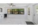 Inviting living room with a large window, sleek tile flooring, and a ceiling fan at 8712 Sw 92Nd St # C, Ocala, FL 34481