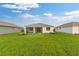 The home features a sizable lawn and covered porch ideal for relaxing or entertaining at 8783 Sw 69Th Place Rd, Ocala, FL 34481