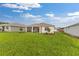 Expansive backyard with a covered patio and lush green grass, perfect for outdoor activities at 8783 Sw 69Th Place Rd, Ocala, FL 34481