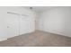 Well-lit bedroom with carpet flooring, closet and neutral wall color at 8783 Sw 69Th Place Rd, Ocala, FL 34481