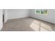 Bright bedroom showcasing neutral carpet, natural light from a window, and ample space at 8783 Sw 69Th Place Rd, Ocala, FL 34481