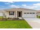 Inviting single-story home featuring a well-kept lawn, and a convenient two-car garage at 8783 Sw 69Th Place Rd, Ocala, FL 34481