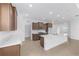 Modern kitchen featuring granite countertops, an island with a sink, and wood cabinets at 8783 Sw 69Th Place Rd, Ocala, FL 34481