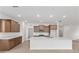 Spacious kitchen featuring granite countertops, an island with a sink, and wood cabinets at 8783 Sw 69Th Place Rd, Ocala, FL 34481