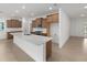 Open concept kitchen with quartz countertops, a center island, wood cabinets, and stainless steel appliances at 8783 Sw 69Th Place Rd, Ocala, FL 34481