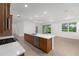 Modern kitchen featuring granite countertops, an island with a sink, and wood cabinets at 8783 Sw 69Th Place Rd, Ocala, FL 34481