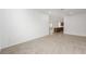 Empty living room with neutral carpet, white walls, and ample natural light at 8783 Sw 69Th Place Rd, Ocala, FL 34481