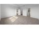 Empty main bedroom showing neutral colored carpet, white walls, and multiple doors at 8783 Sw 69Th Place Rd, Ocala, FL 34481