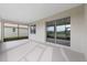 A covered patio with large sliding glass doors opens to a spacious backyard at 8783 Sw 69Th Place Rd, Ocala, FL 34481