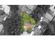 Aerial shot of a charming home in a tree-lined neighborhood with lush greenery at 9 Pine Radial Ct, Ocala, FL 34472