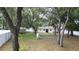 Large, tree-filled backyard with a shed and a white fence offering privacy at 9 Pine Radial Ct, Ocala, FL 34472