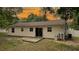 Features a sliding glass door with a small deck, complemented by a well-maintained lawn at 9 Pine Radial Ct, Ocala, FL 34472
