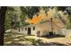 Backyard features a white-sided house with a sliding glass door, a small deck, and a spacious yard at 9 Pine Radial Ct, Ocala, FL 34472