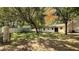 Expansive backyard with lush green grass, mature trees, storage shed and privacy fence at 9 Pine Radial Ct, Ocala, FL 34472