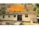 Exterior view of the backyard, highlighting the sliding glass door and small deck, set against a serene backdrop at 9 Pine Radial Ct, Ocala, FL 34472