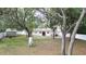 Backyard with lush trees, a shed, and a privacy fence creating a secluded oasis at 9 Pine Radial Ct, Ocala, FL 34472