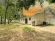 A backyard view showcasing the home's exterior, sliding door, deck, and expansive yard at 9 Pine Radial Ct, Ocala, FL 34472