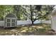 Fenced backyard with a storage shed, providing a private and functional outdoor space at 9 Pine Radial Ct, Ocala, FL 34472