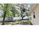View of a fenced yard with a storage shed, and abundant trees offering shade and privacy at 9 Pine Radial Ct, Ocala, FL 34472