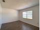 Comfortable bedroom featuring a large window and dark wood-look flooring at 9 Pine Radial Ct, Ocala, FL 34472