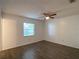 Cozy bedroom with dark wood-look floors and a ceiling fan for added comfort at 9 Pine Radial Ct, Ocala, FL 34472
